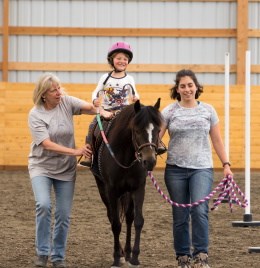 A child in our inclusive Riding Program